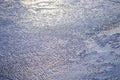 Frozen lake ice background with sunlight on