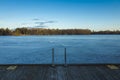 Frozen lake with ice and wood bridge in Sweden at spring evening Royalty Free Stock Photo