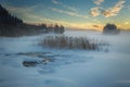 Frozen lake Jonsvatnet near Trondheim, Norway. Sunset light over gathering fog Royalty Free Stock Photo