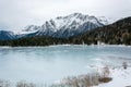 The frozen lake Lautersee near Mittenwald with snowy mountains Royalty Free Stock Photo