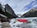 Frozen Lake Louise Lake in Banff National Park with the red canoes Royalty Free Stock Photo