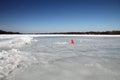 Frozen lake with a red cone mark