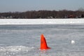 Frozen lake with a red cone mark