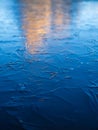 A frozen lake and reflections on the surface. Mountains during dawn. Abstract background. Detail in nature.