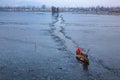 On the frozen lake of snow, Kashmiri driving the shikara through the path Srinagar, Kashmir, India Royalty Free Stock Photo