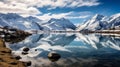 Frozen lake and snowcapped mountains in winter landscape