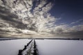 Frozen lake at sunset viewed form a pier.