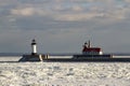 Frozen Lake Superior shoreline with lighthouses and shipping pie Royalty Free Stock Photo