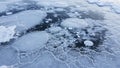 Frozen lake surface featuring trapped methane bubbles beneath a clear ice layer Royalty Free Stock Photo