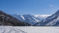 The frozen lake is surrounded by mountains. Royalty Free Stock Photo