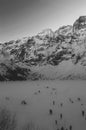 Frozen lake surrounded by snowy mountains