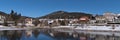 Frozen lake and village Schluchsee, Germany in Black Forest mountain range with snow-covered houses, forest and tower. Royalty Free Stock Photo