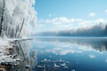 Frozen lakeside bordered by ice-covered trees under a clear blue sky.