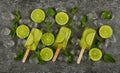 Frozen lime and mint ice popsicles on table Royalty Free Stock Photo