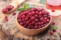 Frozen Lingonberry berries in a wooden bowl