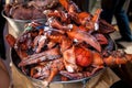 Frozen lobster claws in metal bucket at restaurant