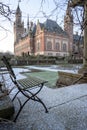 Frozen lonely chair at Peace Palace garden, International Court of Justice, under the Snow Royalty Free Stock Photo