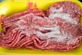 Frozen low-fat beef, raw minced meat in a yellow disposable foam container Royalty Free Stock Photo