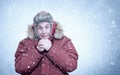 Frozen man in red winter clothes warming hands, cold, snow, frost, blizzard Royalty Free Stock Photo