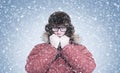 Frozen man in red winter clothes warming hands, cold, snow, frost, blizzard Royalty Free Stock Photo