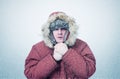 Frozen man in winter clothes warming hands, cold, snow, blizzard Royalty Free Stock Photo