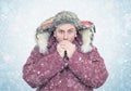 Frozen man in winter clothes warming hands, cold, snow, blizzard Royalty Free Stock Photo