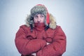 Frozen man in winter clothes warming hands, cold, snow, blizzard Royalty Free Stock Photo