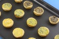 Frozen mini quiches on baking pan