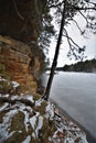 Frozen Mirror Lake state park trees clinging to the sandstone