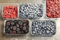 Frozen mixed berries in plastic containers, preserved forest fruits for winter time