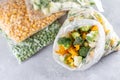 Frozen mixed vegetables in a bag on a light concrete background. Frozen food Royalty Free Stock Photo