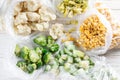 Frozen mixed vegetables in a bag on white wooden table. Frozen food. Top view Royalty Free Stock Photo