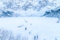 Frozen Morskie Oko Eye of the Sea lake with people in winter in Tatra mountain, Poland Royalty Free Stock Photo