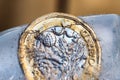 Frozen New British one pound sterling coin up close macro inside ice cubes