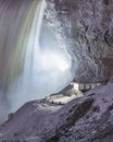 Frozen Niagara Falls during a winter storm lit up at night with snow and ice covering a viewing platform Royalty Free Stock Photo