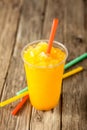 Frozen Orange Slushie in Plastic Cup with Straw Royalty Free Stock Photo