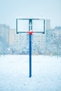 Frozen outdoor basketball hoop in winter snow