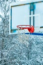 Frozen outdoor basketball hoop in winter snow