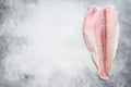 Frozen pangasius fish fillet. Gray background. Top view. Copy space