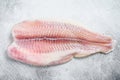 Frozen pangasius fish fillet. Gray background. Top view