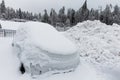 Frozen parked car, covered in a lot of snow