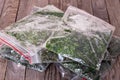 Frozen parsley in plastic bags on a table