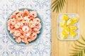 Frozen pilled prawns with ice cubes and lemon slices Royalty Free Stock Photo