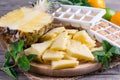 Frozen pineapple on a cutting board on a table Royalty Free Stock Photo