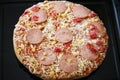 Frozen pizza with salami, cheese, corn and pepper Royalty Free Stock Photo