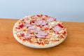 Frozen pizza on wooden table Royalty Free Stock Photo