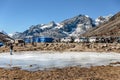 Frozen pond with tourists and market with Yunthang Valley in the background in winter in Zero Point at Lachung. North Sikkim.