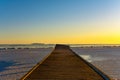 frozen pontoon on the lake in winter at sunrise 045