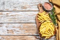 Frozen potatoes in a bowl, French fries, canned food. White background. Top view. Copy space