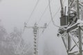 Frozen power line pylons. Hoarfrost on high voltage cables and pylons. Winter in the mountains Royalty Free Stock Photo